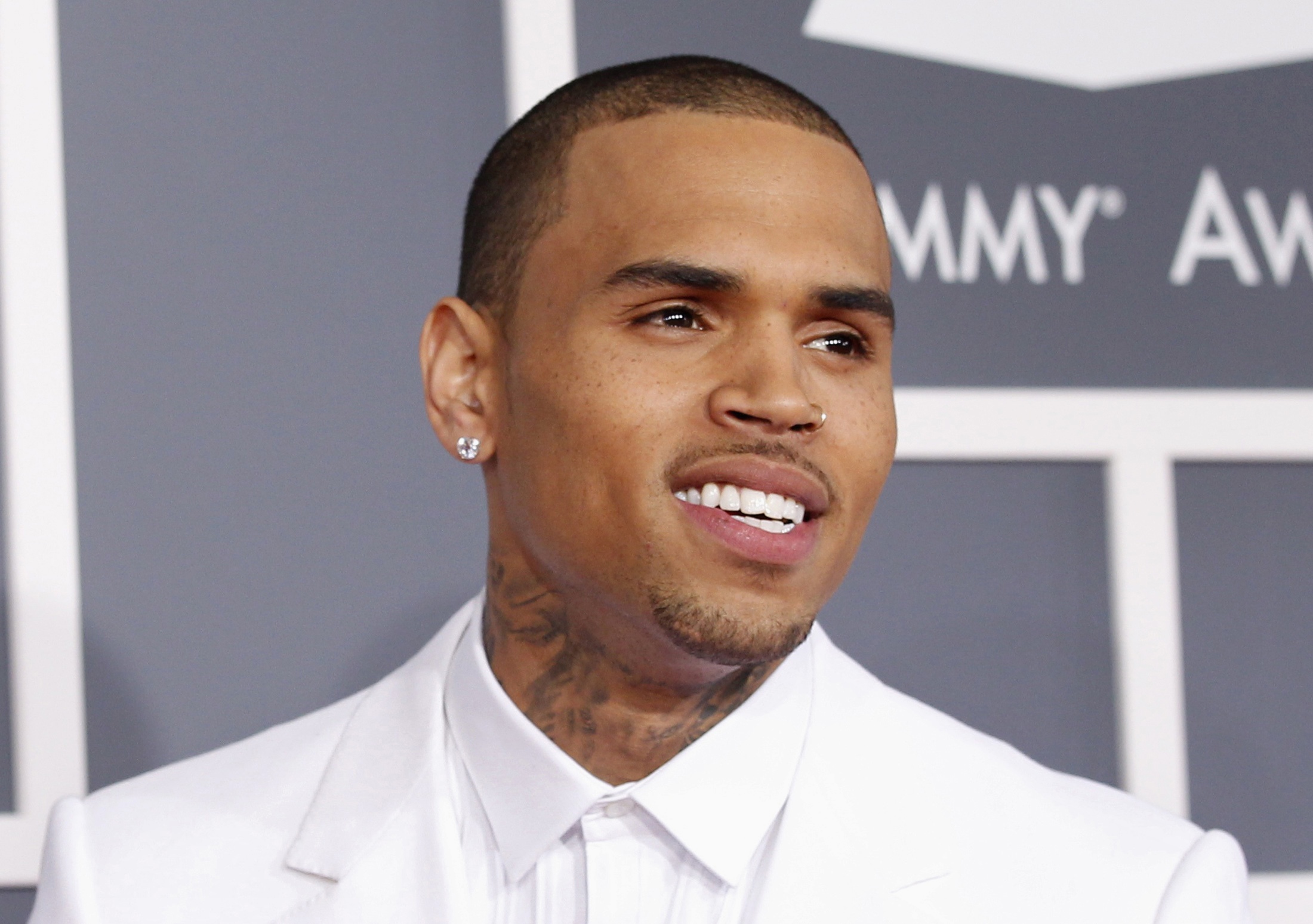 Singer Chris Brown arrives at the 55th annual Grammy Awards in Los Angeles, California in this February 10, 2013 file photo.  Brown, on probation for punching and beating his former girlfriend, was charged on June 25, 2013 with a hit-and-run and driving without a valid license in connection with a May 21 traffic accident in Los Angeles.  REUTERS/Mario Anzuoni/Files (UNITED STATES - Tags: ENTERTAINMENT CRIME LAW)