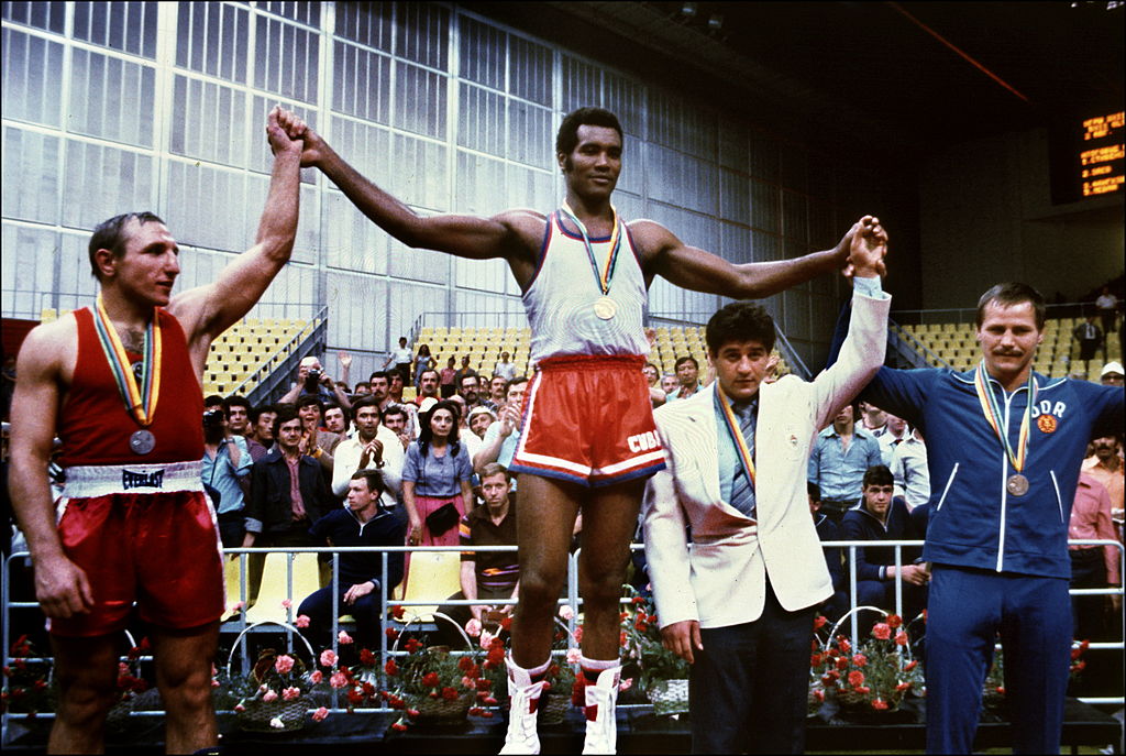 Cuban champion Teofilo Stevenson (C-gold medal) Soviet Pyotr Zaev (L-silver medal) and German Republic Democratic Jurgen Fanghanel (R- bronze medal) wawe on the podium of the Olympic heavyweight 81+ boxing event that won Teofilo Stevenson. Stevenson --who won 301 of the 321 fights he took part-- died of a heart attack at the age of 60 in Havana on June 11, 2012. AFP PHOTO (Photo credit should read STAFF/AFP/GettyImages)