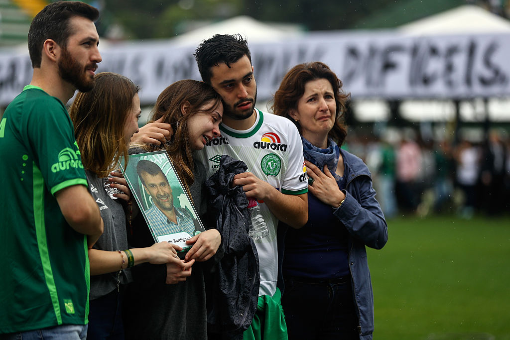 CHAPECO, BRAZIL - DECEMBER 03:  Relatives of the members of Brazilian team Chapecoense Real pay a tribute at the club's Arena Conda stadium in Chapeco, in the southern Brazilian state of Santa Catarina, on December 03, 2016. The players were killed in a plane accident in the Colombian mountains. Players of the Chapecoense team were among the 77 people on board the doomed flight that crashed into mountains in northwestern Colombia. Officials said just six people were thought to have survived, including three of the players. Chapecoense had risen from obscurity to make it to the Copa Sudamericana finals scheduled for Wednesday against Atletico Nacional of Colombia.  (Photo by Buda Mendes/Getty Images)