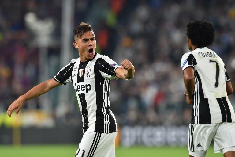 Juventus' forward from Argentina Paulo Dybala celebrates after scoring during the UEFA Champions League quarter final first leg football match Juventus vs Barcelona, on April 11, 2017 at the Juventus stadium in Turin.  / AFP PHOTO / GIUSEPPE CACACE
