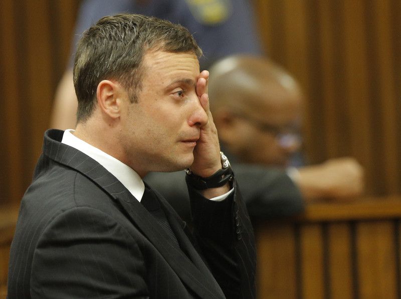 epa04395082 South African Paralympic athlete Oscar Pistorius reacts in the dock during the verdict in his murder trial, Pretoria, South Africa, 11 September 2014.  Pistorius awaits his verdict after standing trial from 03 March 2014 for the premeditated murder of his model girlfriend Reeva Steenkamp in February 2013.  EPA/KIM LUDBROOK/POOL